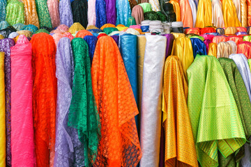 Rolls colorful of brightly coloured fabrics and cloths store