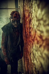 frightening zombie at wall