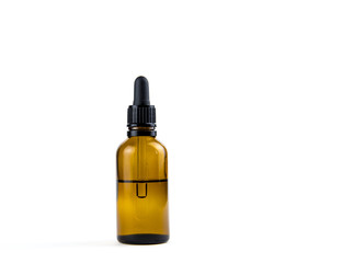 Small brown medical pipette glass bottle isolated on white background. A lot of empty room and space for text.