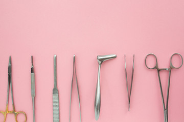 Flat lay of medical instruments on rose background. Mock up health care medical background.