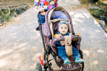 baby is sitting on carriage alone. Baby in sitting stroller on nature