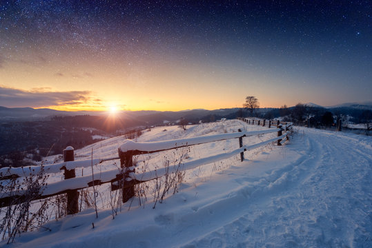 Beautiful Winter Fairytale Landscape, Stars And Rising Sun Over The Snowy Mountain Road