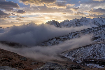 Great view of the foggy valley in Gran Paradiso National Park,  Alps, Italy,  dramatic scene, beautiful world. colourful autumn morning,scenic view with cloudy sky, majestic dawn in mountain landscape