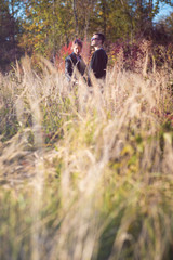 Young couple hugging in autumn nature setting