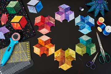 Preparing of bright diamond pieces of fabrics for sewing tumbling quilt, traditional patchwork,...