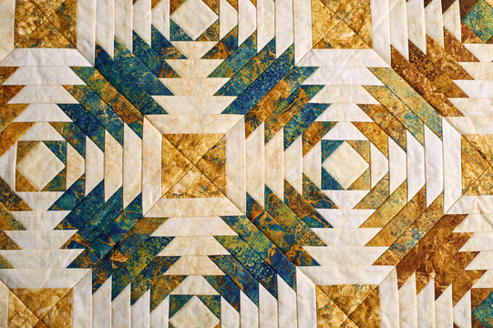 Fragment of quilt stitched from pineapple pattern blocks