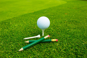 Golf Ball and Tee on Grass