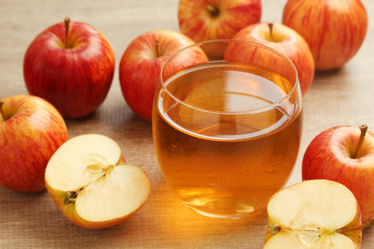 A glass with juice and apples