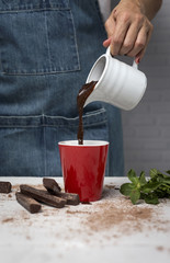 woman's hands close up holding a cup of chocolate