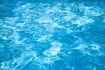 Fototapeta na wymiar blue pool water with sunny highlights