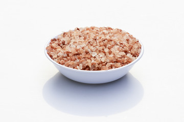 close-up in white container filled with granulated pink salt
