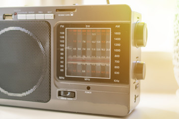 hand adjusting the settings of vintage old radio, search for radio station wave f
