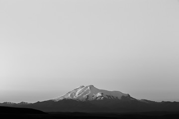 Mount Elbrus at dawn. View of the sunlit slopes of the volcano from the northwest. The North...