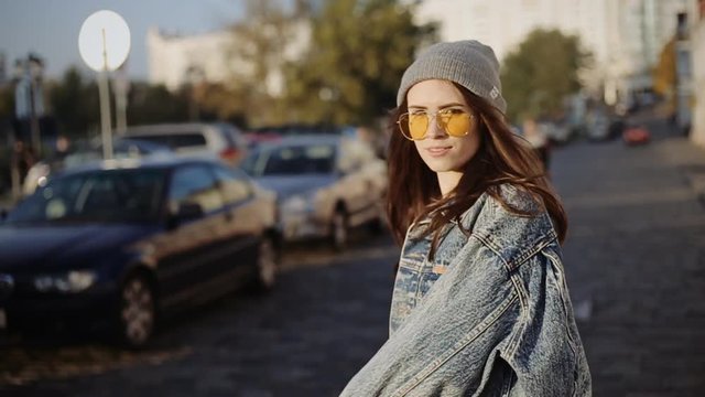Pretty cool teen girl posing in the city, slow motion