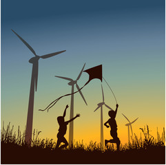 Renewable energy. Children play with a kite near wind generators against the background of a sunset.
