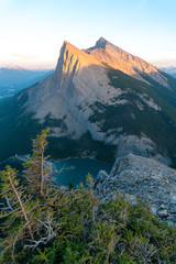 The last orange light catches the rugged edges of a distant point from the edge of a precipice 