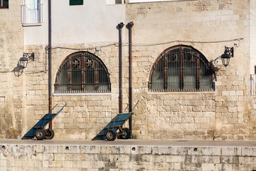 Abandoned empty vendor cart near traditional fish market in Monopoli port, Apulia, Bari province,...