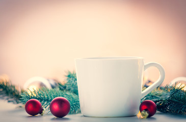 Cup and christmas decoration and baubles around