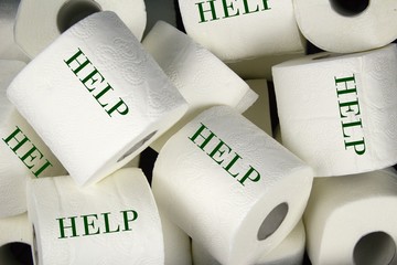 Many rolls of white toilet paper. A matter of daily necessity with inscription Help