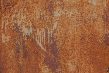painted iron surface with a large rusty and metal corrosion, old background with peeling and...