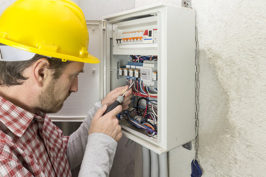 electrician at work on an electrical panel