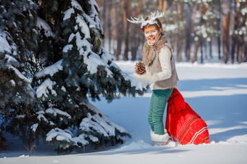 Fototapeta na wymiar Smiling boy with funny antlers of a deer. Holiday concept.