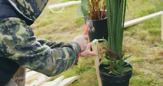 Close up of gardener setting composition of flowers