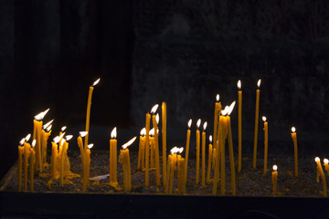 Burning wax candles in the church
