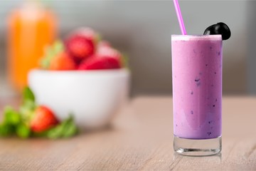 Glass of delicious berry cocktail on perple