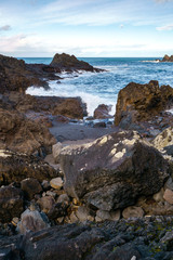 Fototapeta na wymiar Seascape with waves crashing on the rocks in Seixal, Madeira