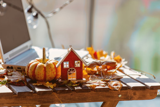 Orange pumpkinm wooden house and leaves