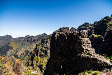 Trekking on the levada trail going across the beautiful meadows and peaks of the highest Madeira mountains, Pico Ruivo i Pico de Arieiro lost in clouds