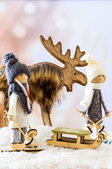 Two skiers and a reindeer at Christmas