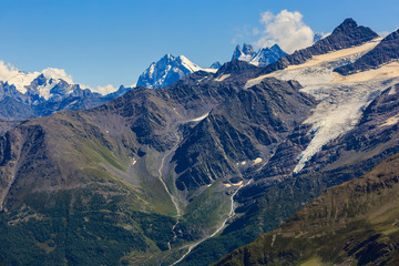 View from Elbrus on the surrounding mountain peaks with snow and glaciers in the North Caucasus.