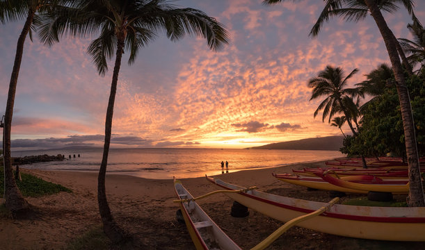 Paddling Canoe on beach in Maui at sunset - Powered by Adobe