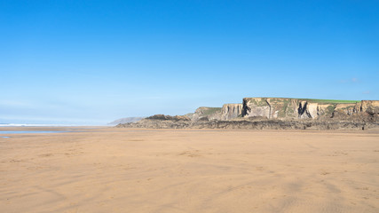 Fototapeta na wymiar Cornwall Bude Beach with cliffs in the background