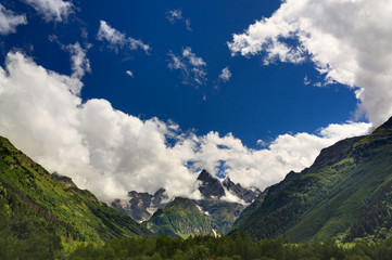 Fototapeta na wymiar Clouds over the rocky ridge of the mountainous region of the North Caucasus in Russia.