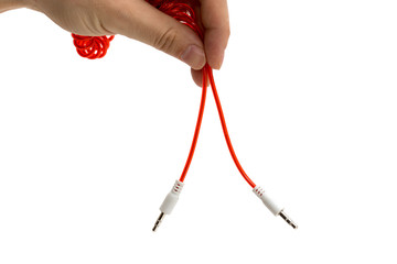 Aux cord in hand on a white background