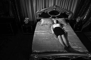 Fototapeta premium Strangled beautiful business woman in a bedroom