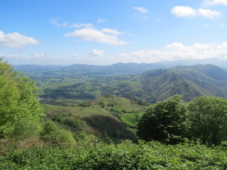 Fototapeta premium Camino de Santiago pilgrimage way in Pyrenees from France St. Jean Pied de Port to Roncesvalles Spain, difficult road, path, bright spring day