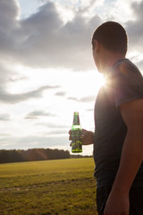 BELGRADE, SERBIA - SEPTEMBER 09, 2018 Carlsberg globaly distributed pale lager beer produced by Carlsberg Group ,Man tourist standing in a field in europe holding a drink ,enjoying 