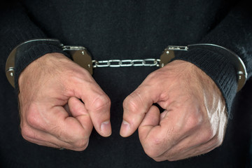 handcuffed hands. arrested criminal