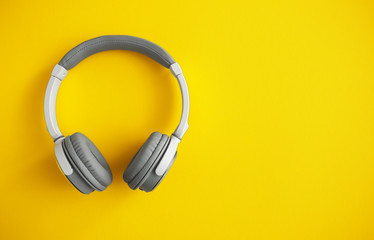 Modern headphones on color background