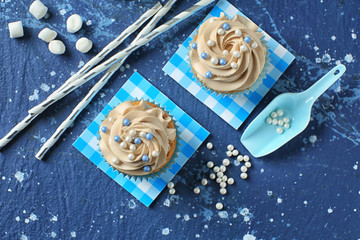 Delicious cupcakes on color table