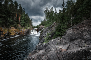 Kivach waterfall on the river Suna in the Republic of Karelia. Cold summer in the northern forests.