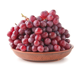 Plate with fresh grapes on white background