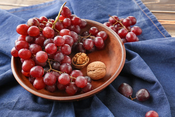 Plate with sweet grapes on color napkin