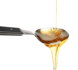 Metal spoon with honey against white background
