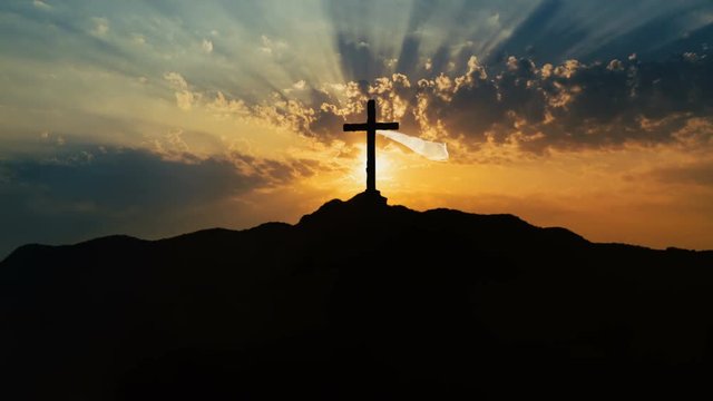 Golgotha hill outside ancient Jerusalem where Jesus Christ was crucified. Holy Cross with mystical clouds and rays of light.