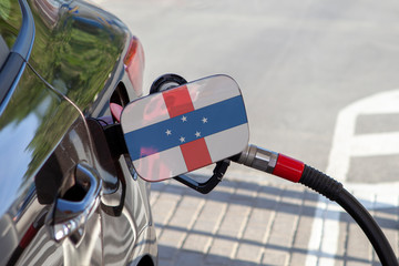 Fueling car with petrol pump at a gas station.